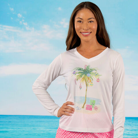Woman wearing a longsleeve shirt with a palm tree on it