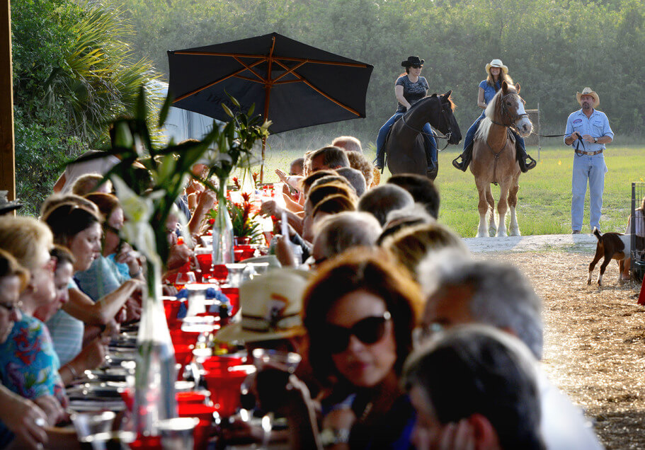 People dining outdoors at a long table