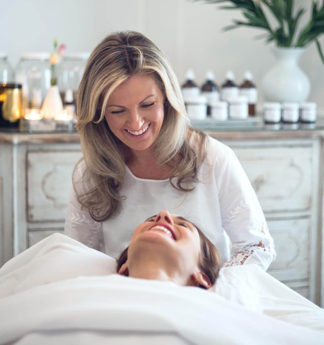 Woman providing a spa service to another woman