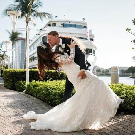 married couple with yacht background