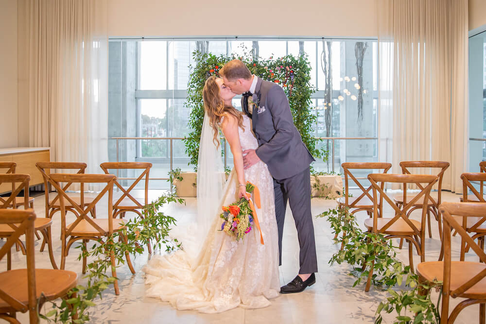 Bride and groom kissing in a wedding venue