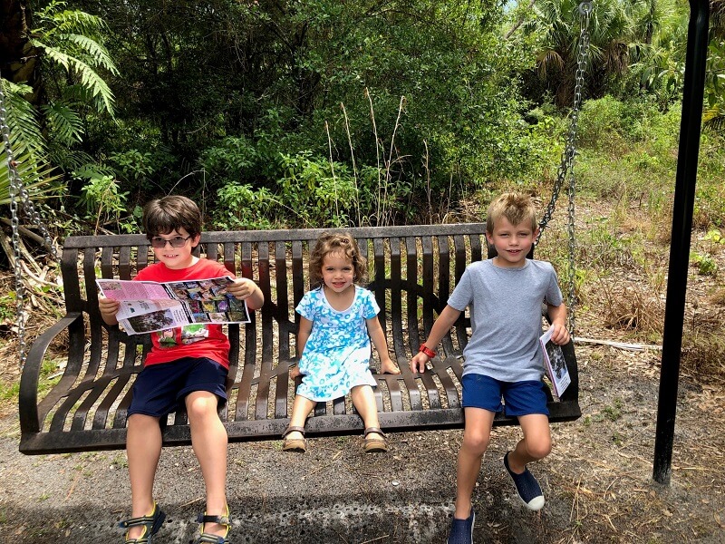 Kids sitting on a bench in a park