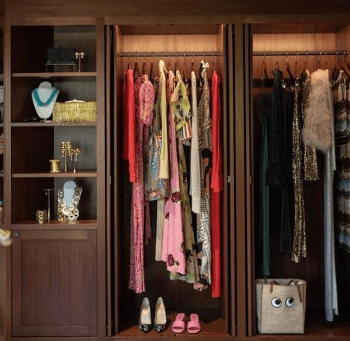 Ein gut organisierter begehbarer Kleiderschrank, gefüllt mit einer Vielzahl farbenfroher Kleidungsstücke und Accessoires