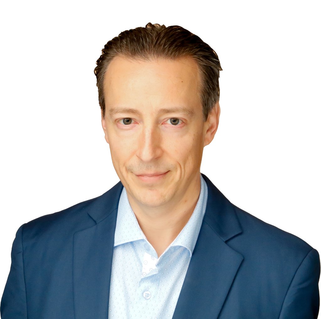 A man wearing a blue suit jacket over a light blue shirt with a subtle pattern