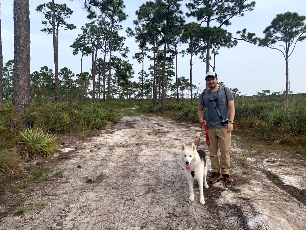A guy walking his dog at Jonathan Dickinson State Park