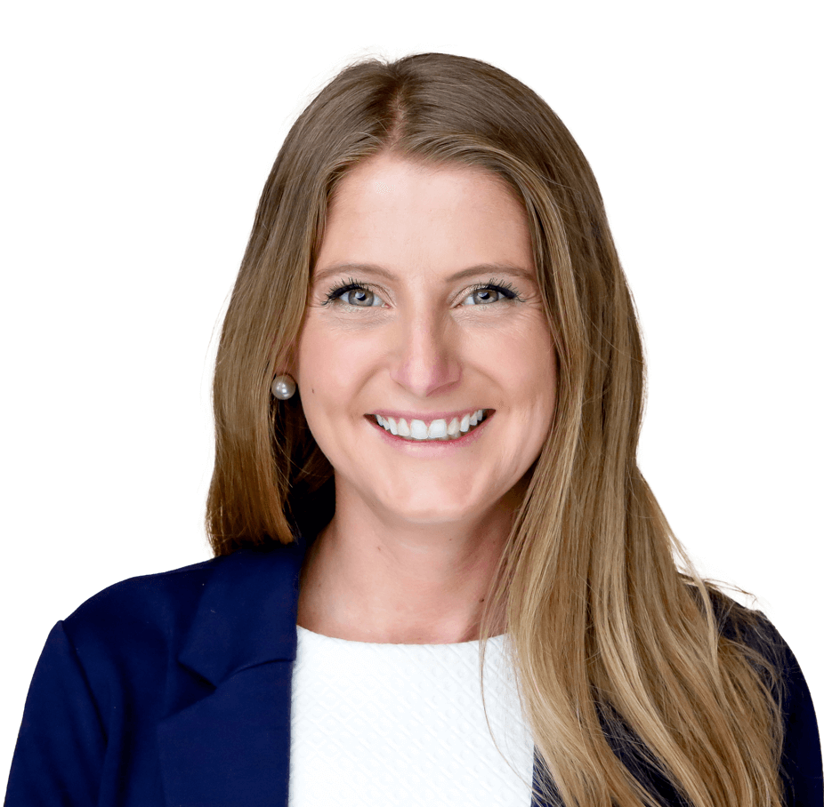 A professional headshot of a smiling woman with long blonde hair wearing a navy blue blazer over a white blouse