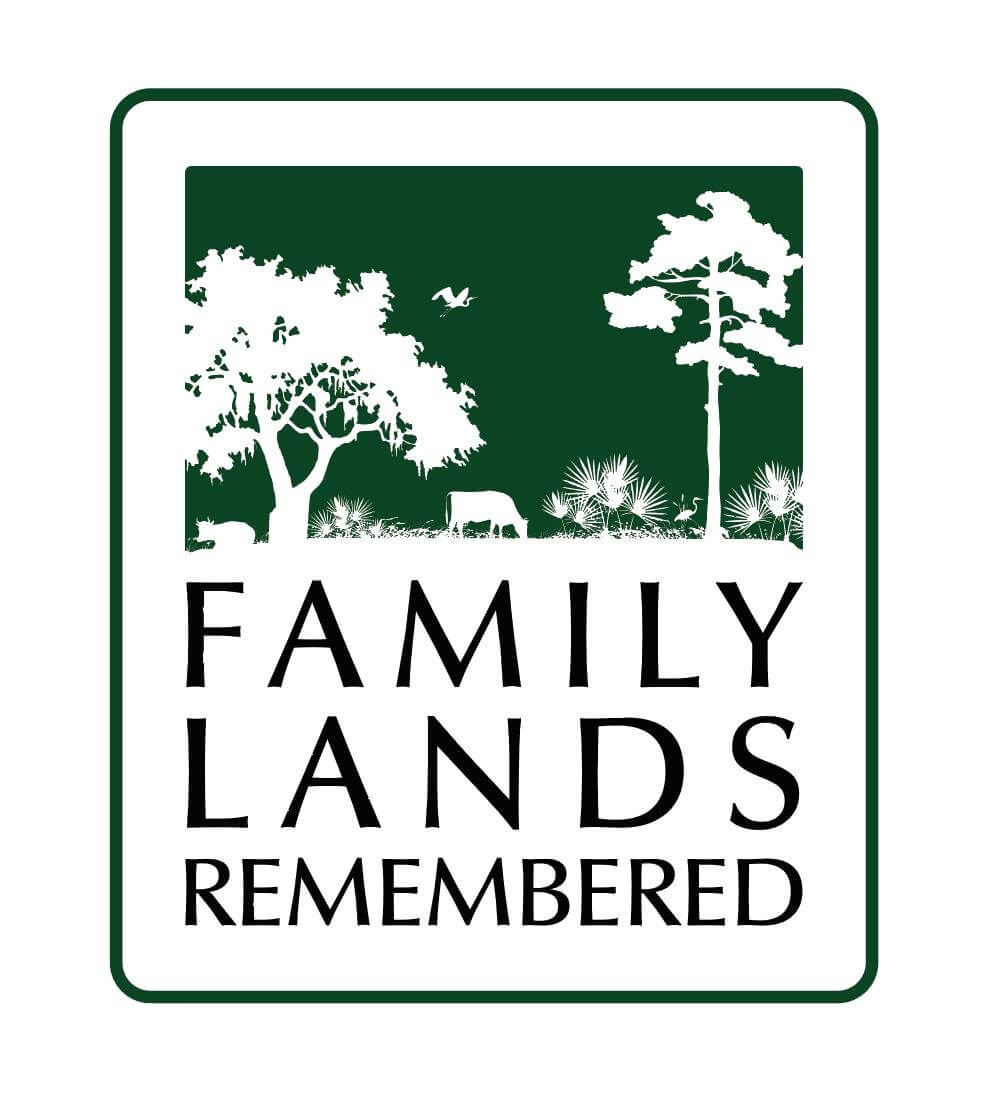 A logo featuring a green landscape silhouette with trees, birds, and cattle