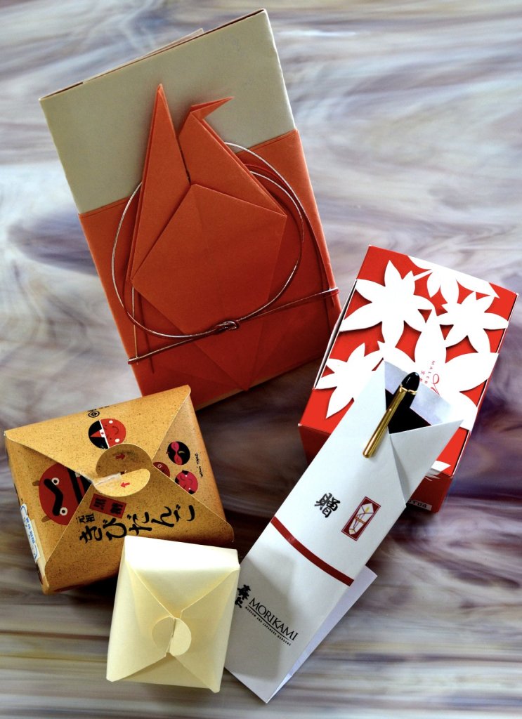 A collection of beautifully crafted Japanese gift boxes and envelopes, featuring origami designs and traditional motifs