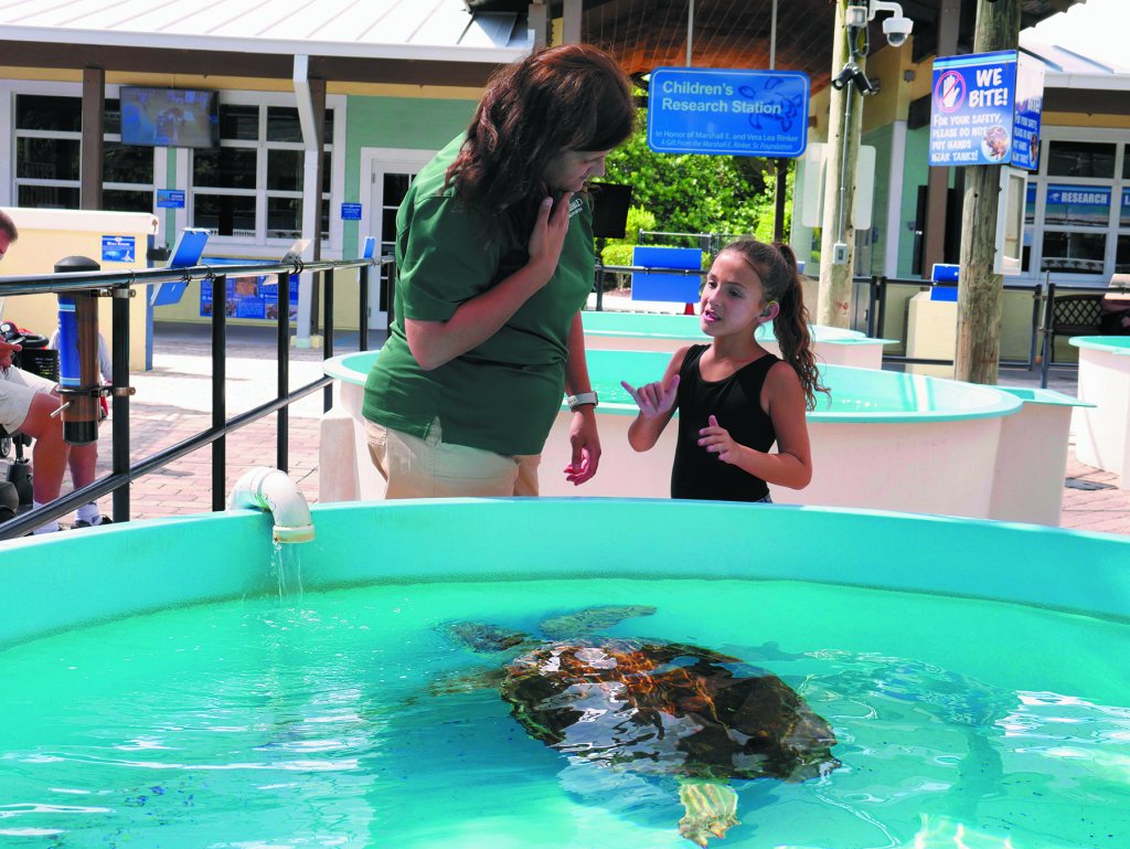 A woman conducting an ASL tour at Loggerhead Marinelife Center