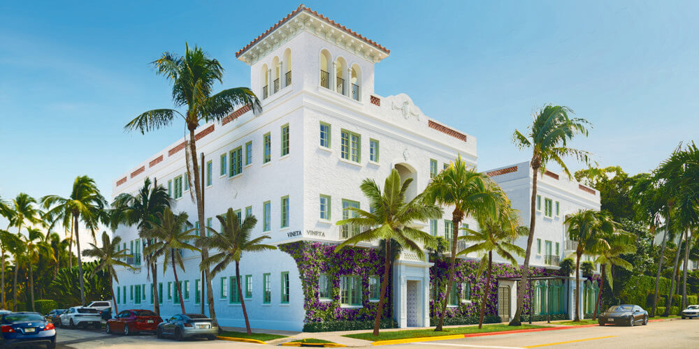 Elegant white building with palm trees.