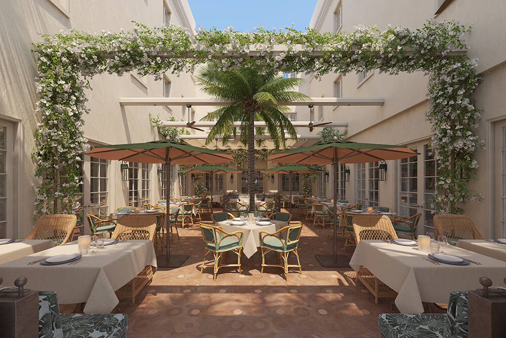 Eine elegante Restaurantterrasse mit weiß blühenden Pergolen, Palmen und Korbmöbeln