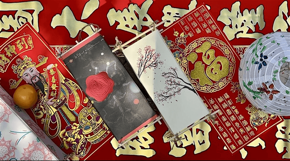A vibrant red tablecloth adorned with golden Chinese characters and symbols, featuring a traditional red envelope, a decorative lantern, and an orange fruit