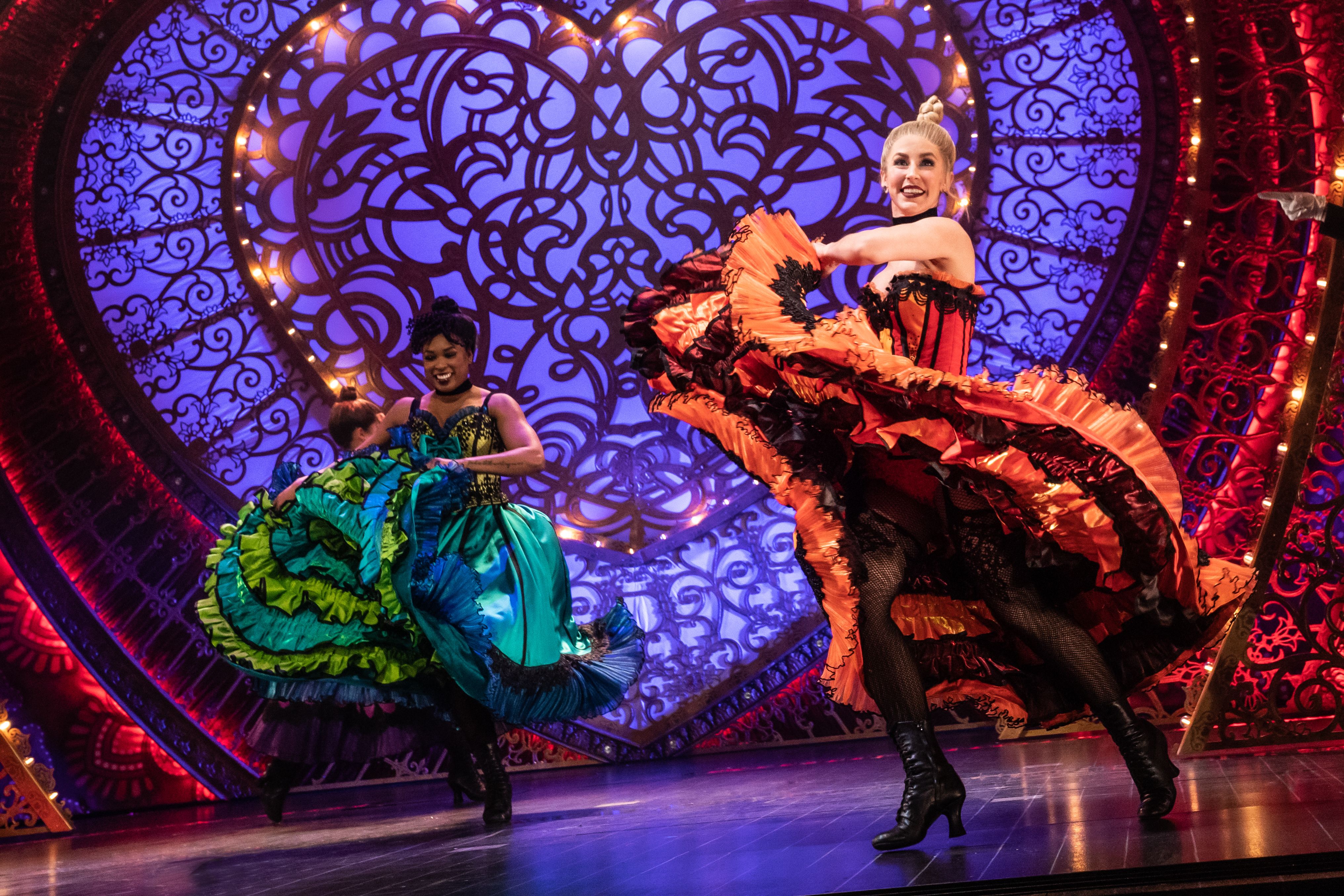 Two ladies on a stage performing the Moulin Rouge at the Kravis Center for the Performing Arts