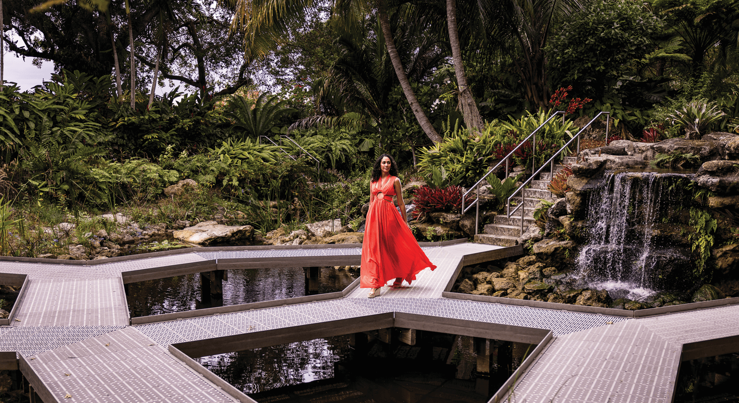 a woman in a red dress at Mounts Botanical Garden