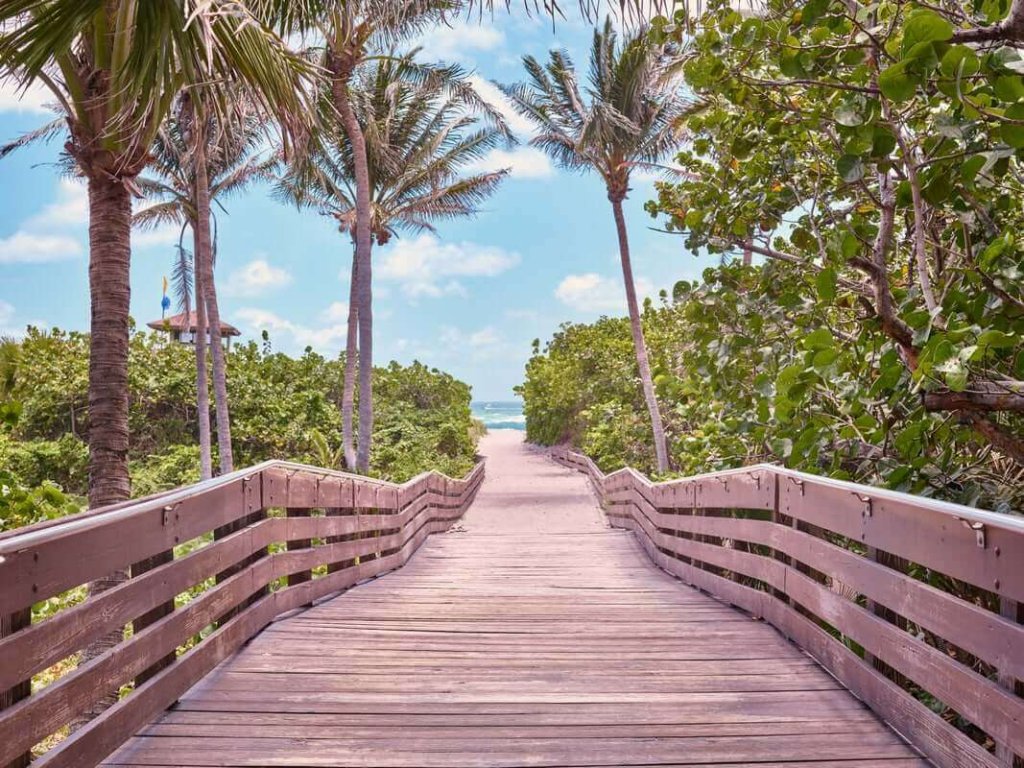 a wooden walkway leading to a beach