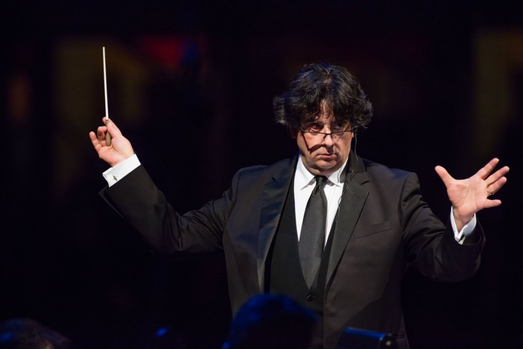 a man in a suit holding a baton