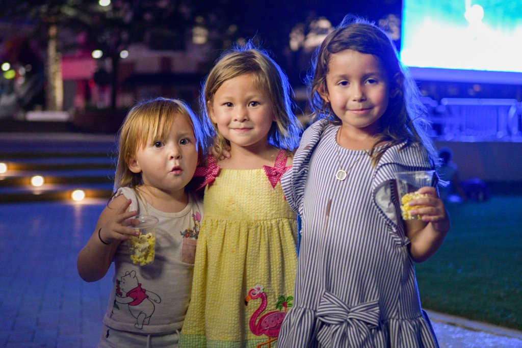 Three kids on the green lawn in West Palm Beach