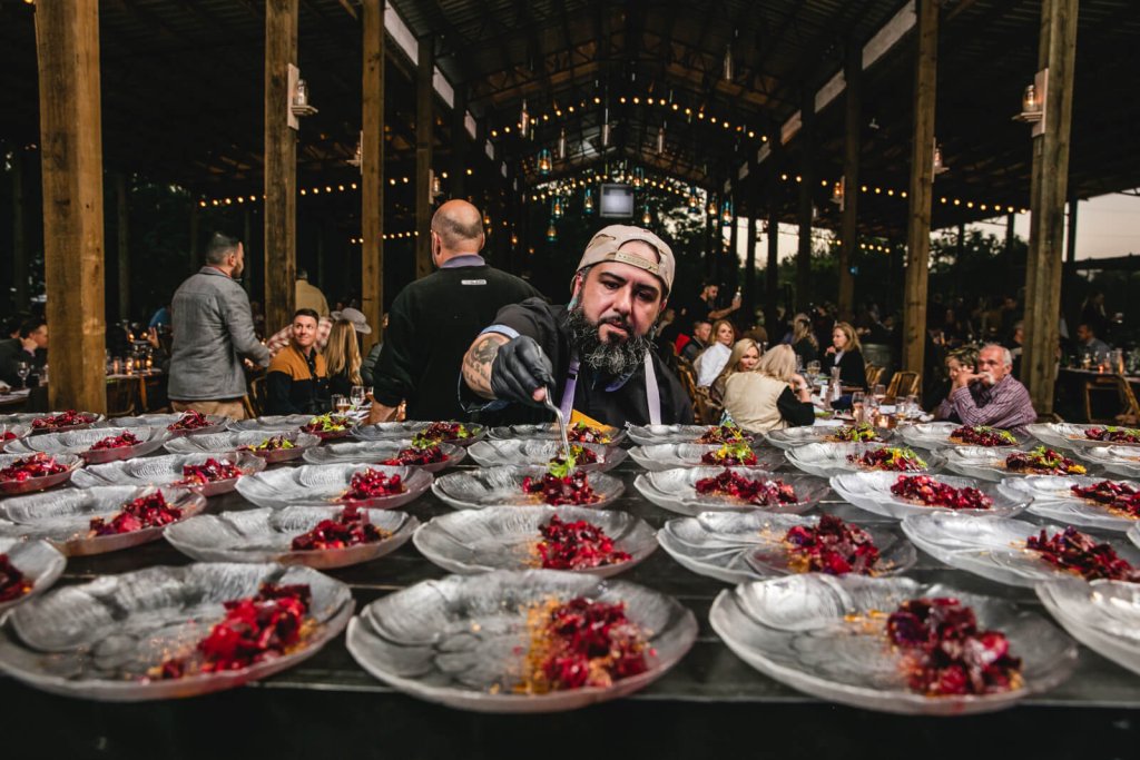 chef preparing dishes at swank table dinner